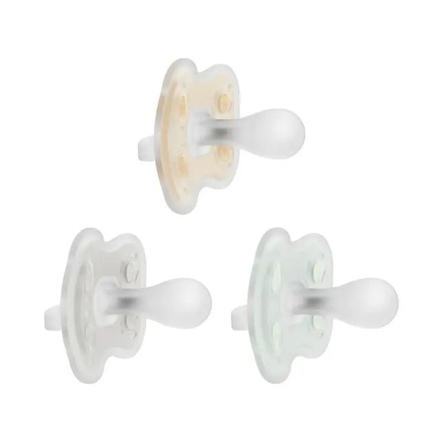 Three white pacifiers on a white background