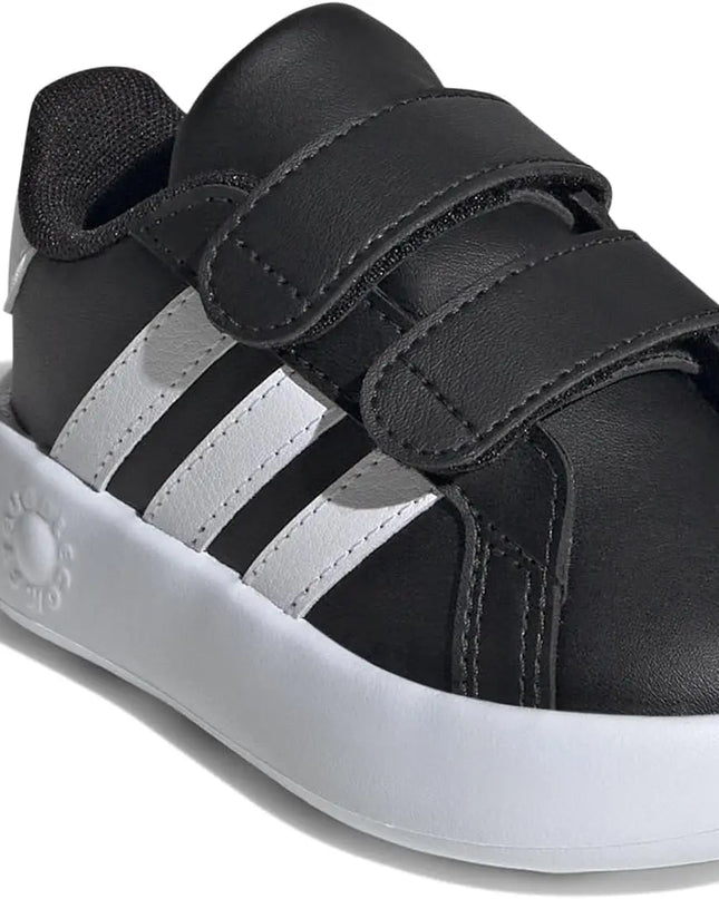 Black and white sneaker with three stripes on a white background