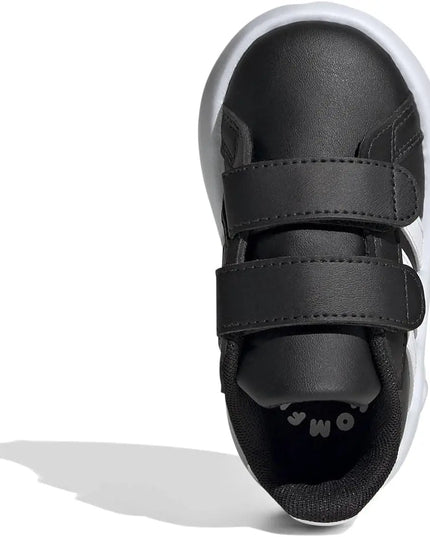 Black children's shoe with velcro straps on a white background