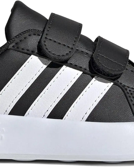 Black and white Adidas baby shoe on a white background