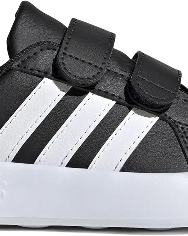 Black and white Adidas baby shoe on a white background