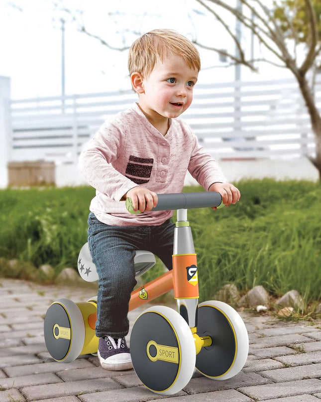 Child riding a balance bike on a paved path with grass and trees in the background