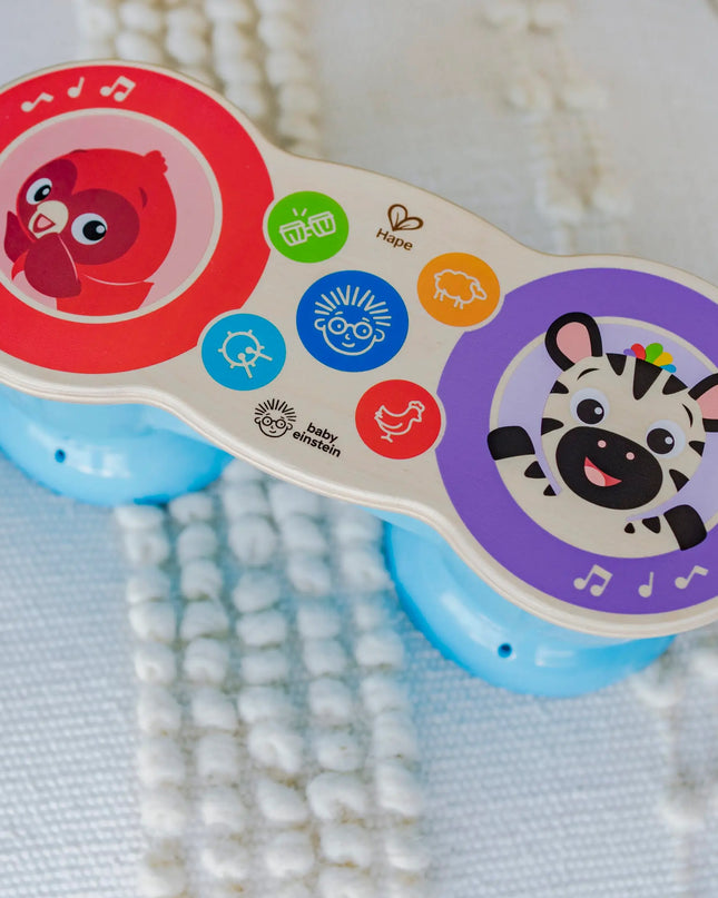 Children's toy with colorful buttons and animal illustrations on a textured fabric background