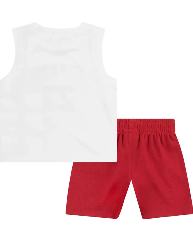 White sleeveless top and red shorts on a white background