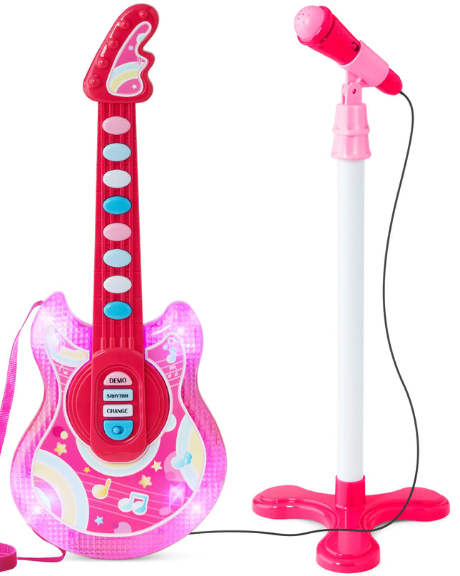Pink toy guitar with microphone stand on a white background