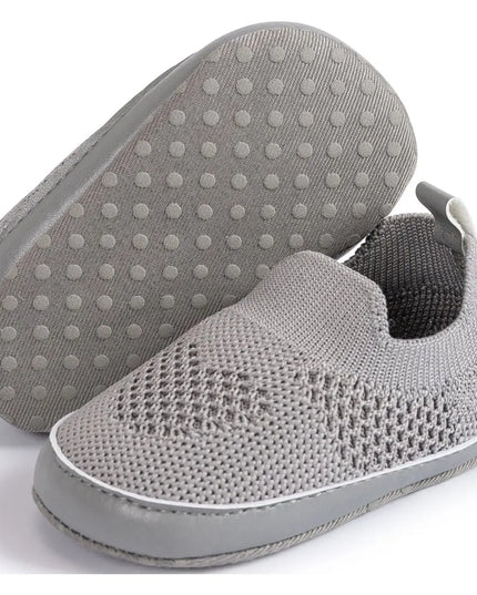 Gray slip-on shoes with textured sole on a white background