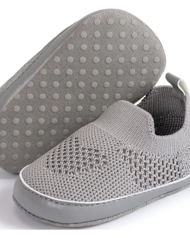Gray slip-on shoes with textured sole on a white background