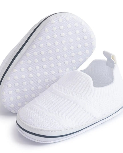 White slip-on shoes with textured sole on a white background