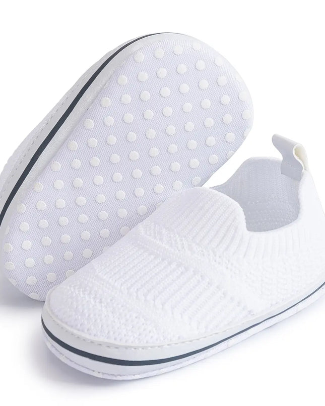 White slip-on shoes with textured sole on a white background