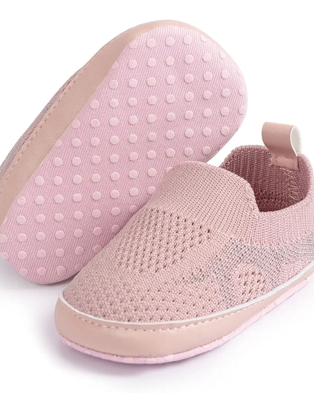 Pink slip-on shoes with textured sole on a white background