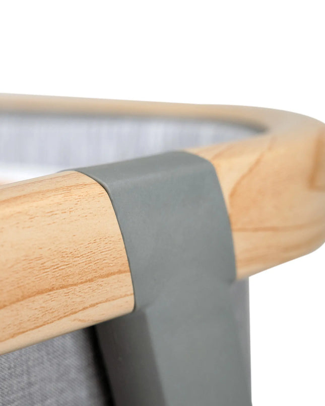 Close-up of a wooden chair with a gray cushion on a white background
