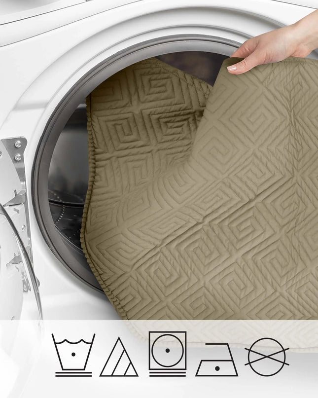 Person placing a textured beige mat into a washing machine with laundry care symbols below.