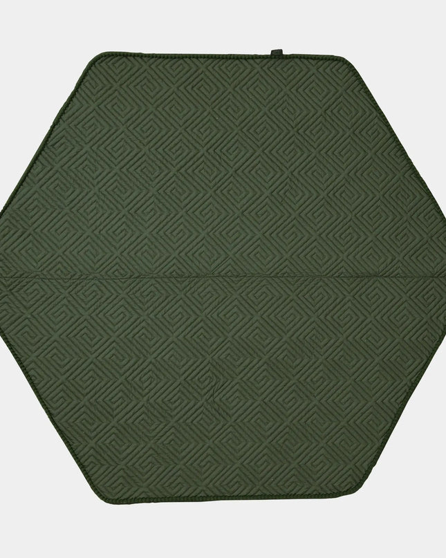 Hexagonal green mat with a geometric pattern on a white background