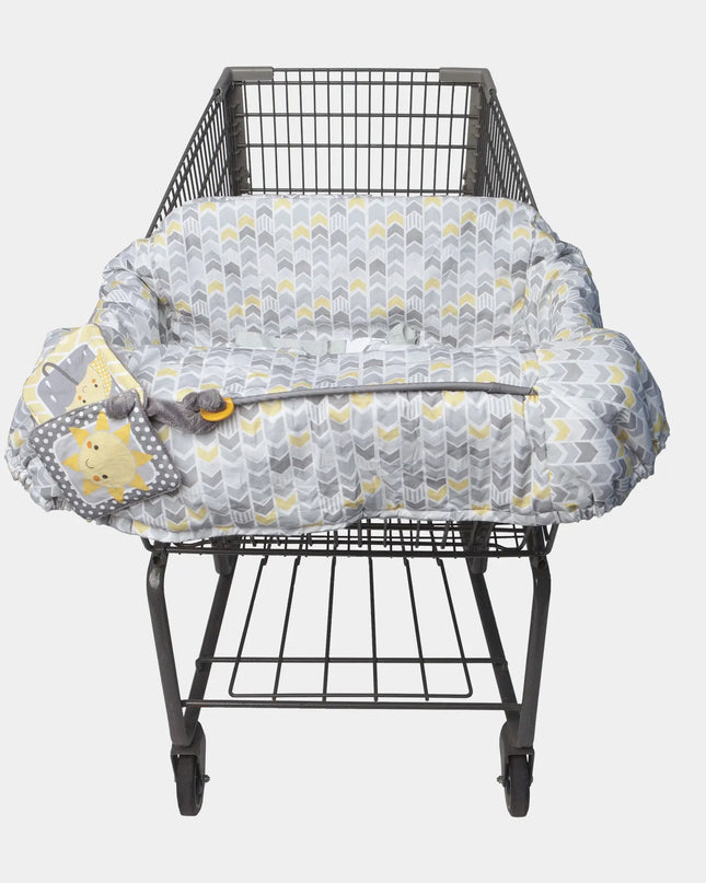 Gray and yellow patterned shopping cart cover on a metal shopping cart against a white background