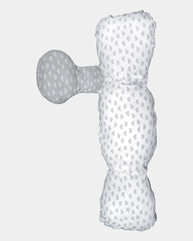 White and gray polka dot dog toy on a light gray background