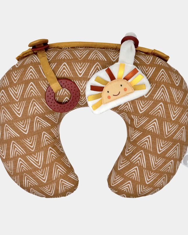 Neck pillow with a patterned design and a toy attached on a white background