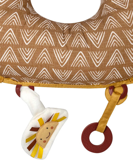 Baby teether with lion design attached to a brown fabric ring with white patterns