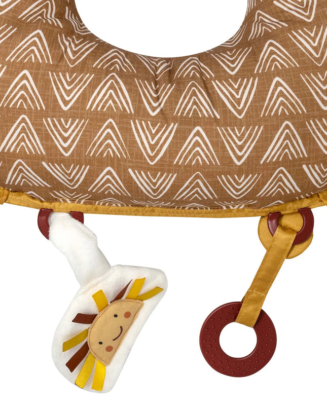 Baby teether with lion design attached to a brown fabric ring with white patterns