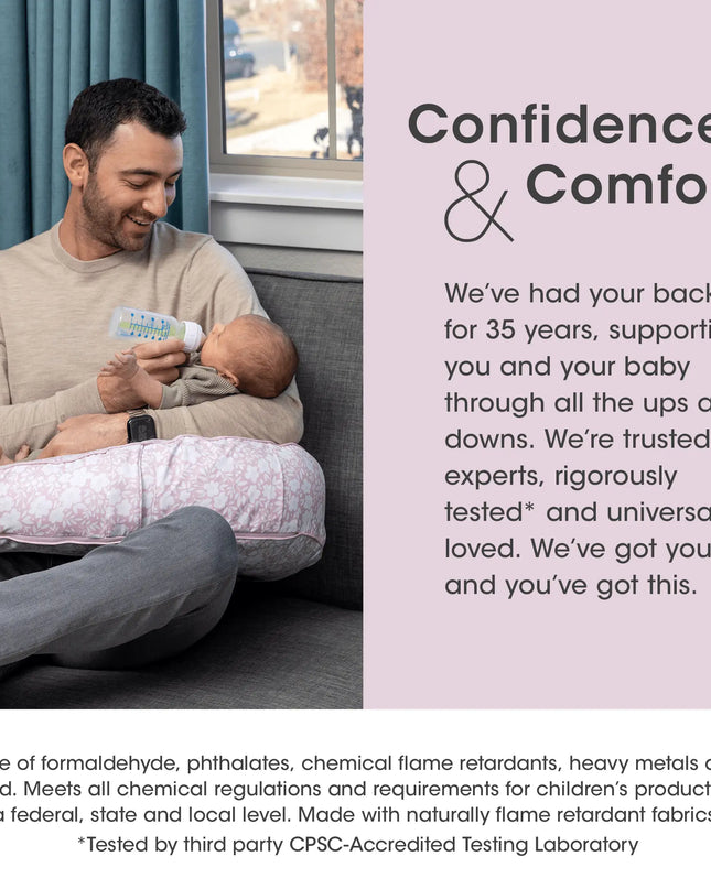 Man holding a baby and bottle with text about confidence and comfort, featuring a product with flame retardant properties.