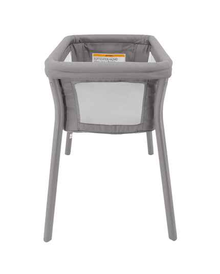 Gray baby bassinet with mesh side on a white background