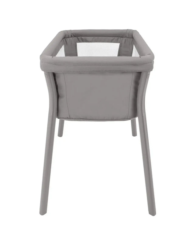 Gray baby crib with white mattress on a white background