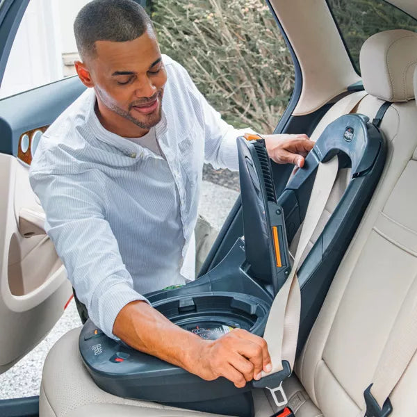 Man adjusting a car seat in a vehicle
