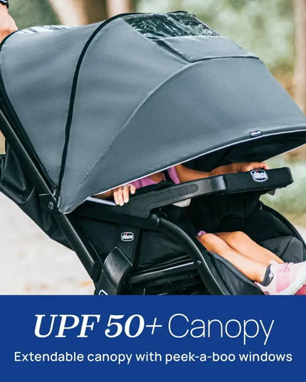 Child in a stroller with a UPF 50+ canopy, outdoor setting