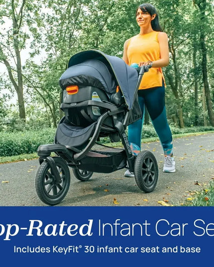 Woman pushing a top-rated infant car seat with KeyFit 30 in a park setting