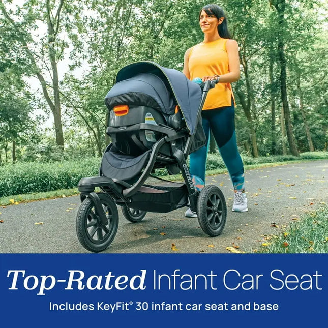 Woman pushing a top-rated infant car seat with KeyFit 30 in a park setting