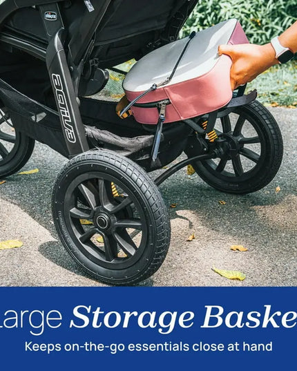 Person placing a pink bag into a stroller with a large storage basket feature highlighted.