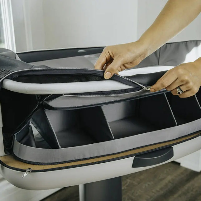 Person opening a gray and black suitcase with a white background
