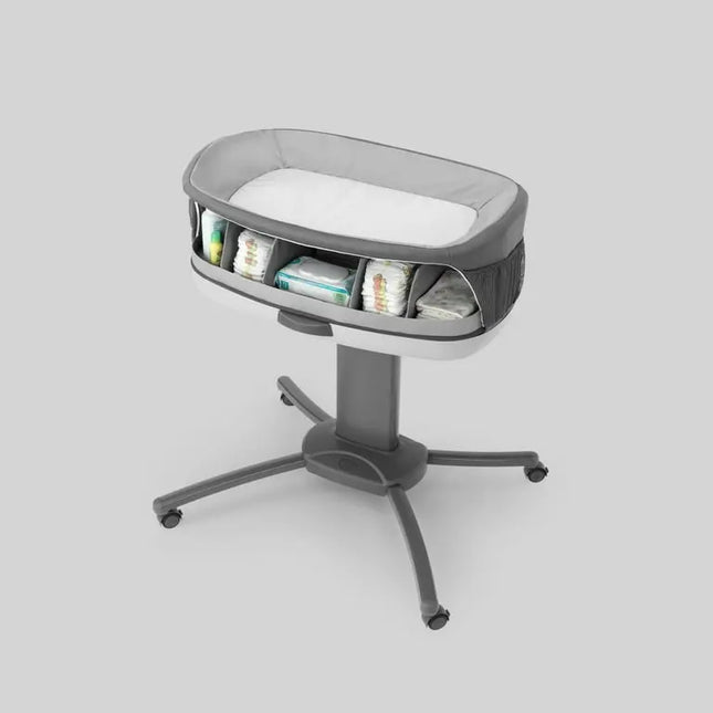 Gray baby bassinet with wheels on a light gray background