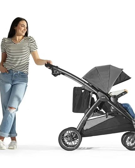Woman pushing a black stroller on a white background