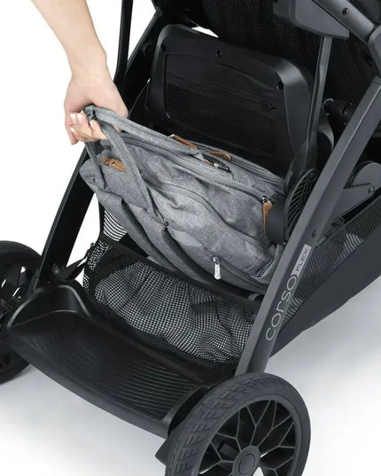 Gray storage bag attached to a black stroller on a white background