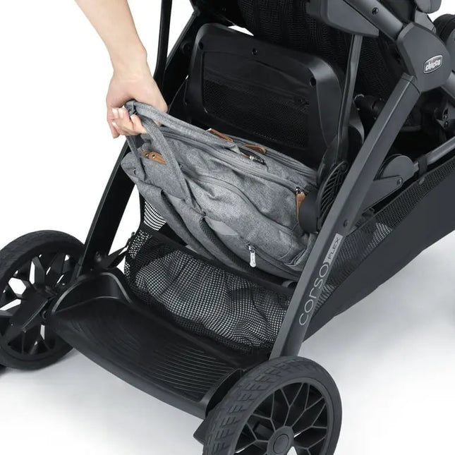 Gray storage bag attached to a black stroller on a white background