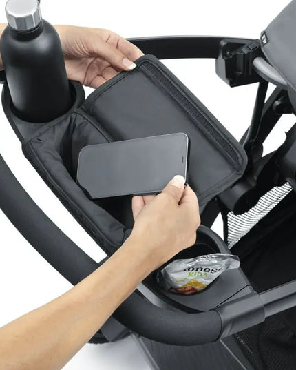 Hand using a phone holder attached to a stroller.