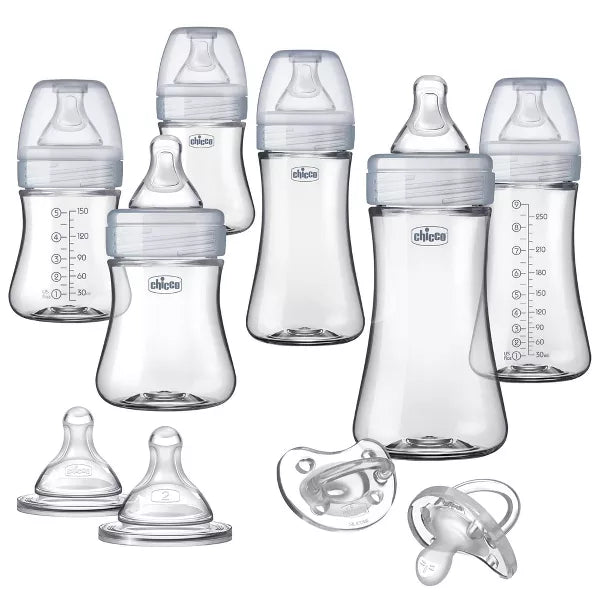 Collection of Chicco baby bottles and pacifiers on a white background