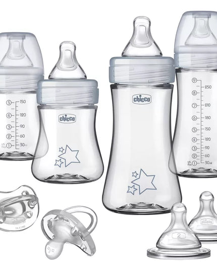 Set of Chicco baby bottles and pacifiers on a white background
