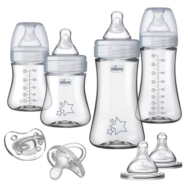 Set of Chicco baby bottles and pacifiers on a white background