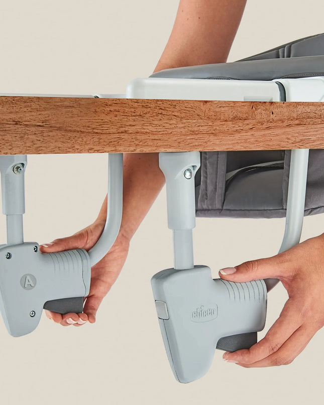 Chair armrest extender being attached to a chair with a neutral background