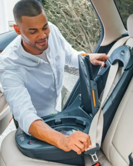 Man installing a car seat in a vehicle