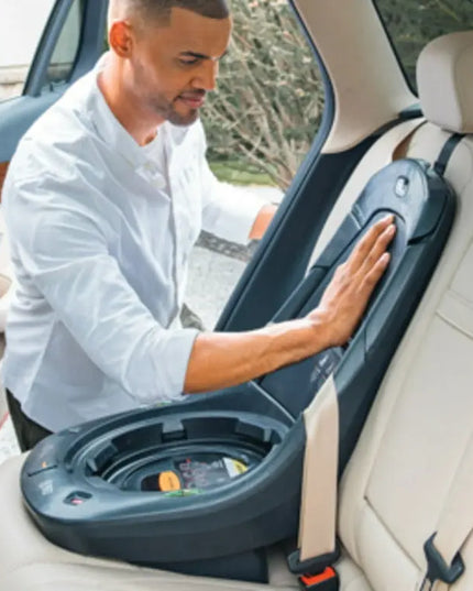 Man adjusting a car seat in a vehicle