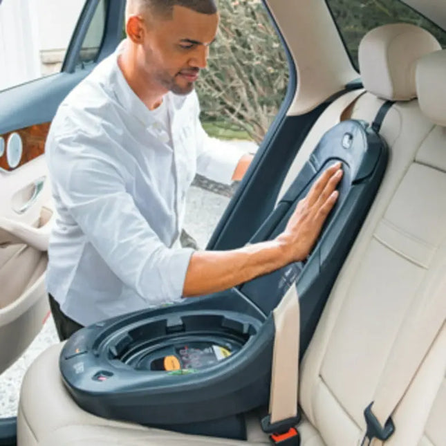 Man adjusting a car seat in a vehicle