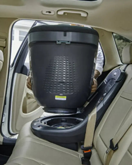 Car seat with a baby in a car seat cover inside a vehicle