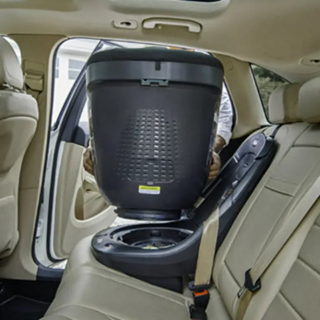 Car seat with a baby in a car seat cover inside a vehicle