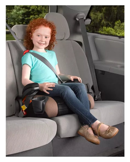 Child sitting in a car seat with a safety harness in a vehicle.