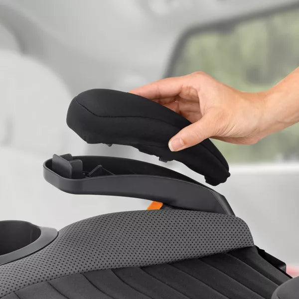 Hand adjusting a car seat cover on a car seat with a blurred background
