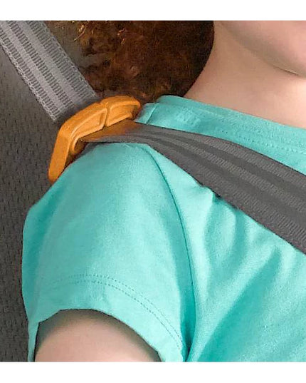 Person wearing a turquoise shirt with a gray shoulder strap over their shoulder.