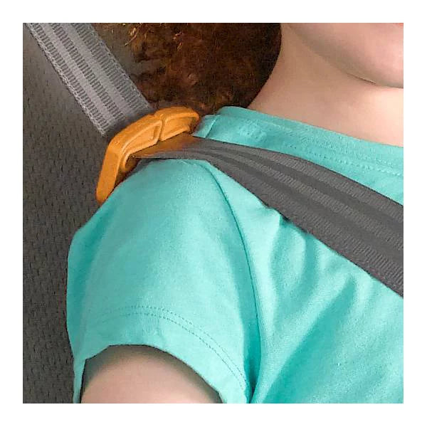 Person wearing a turquoise shirt with a gray shoulder strap over their shoulder.