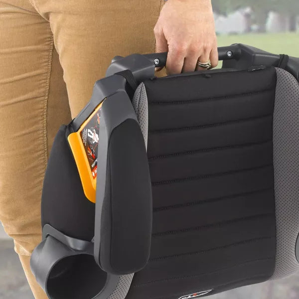 Person holding a black car seat with cup holder attachment outdoors.